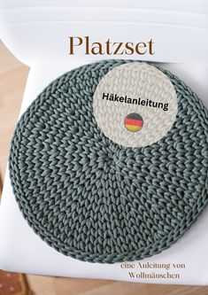 a knitted placemat on top of a white chair with the word plattzet written in german