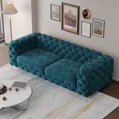 a blue couch sitting on top of a white rug