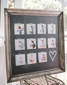 an old frame with photos and a heart drawn on the side is holding a baby's first year photo