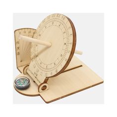 a wooden spinning wheel and compass on a white background