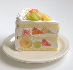 a piece of cake on a plate with fruit toppings