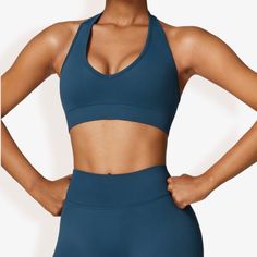 The Anna-Kaci Women's Halter Neck Sports Bra with Elastic Band and V-Neckline is a stylish and functional addition to your activewear collection. Made from soft, stretchy fabric, this sports bra features a flattering V-neckline and a halter neck design that provides excellent support and freedom of movement. The elastic band ensures a secure and comfortable fit, making it perfect for workouts, yoga sessions, or any athletic activity. Pair this versatile sports bra with high-waisted leggings, sho V-neck Yoga Activewear With Light Support, Seamless V-neck Activewear For Pilates, Seamless Stretch V-neck Activewear, Sporty V-neck Sports Bra For Pilates, Seamless V-neck Athleisure Activewear, V-neck Light Support Yoga Activewear, Seamless V-neck Sports Bra In Athleisure Style, V-neck Activewear For Yoga With Light Support, V-neck Activewear With Built-in Bra For Yoga