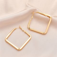 Show off bold accents wearing this pair of hoop earrings featuring 18k gold-plated rhombus designs. 2.2" W x 2.09" L 18k gold-plated copper Rhombus Design, Show Off, 18k Gold, Gold Tones, Gold Plate, Hoop Earrings, Gift Card, Copper, Plating