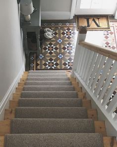 a staircase with carpeted steps and tiled flooring