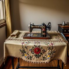 an old sewing machine sitting on top of a wooden table next to a small window