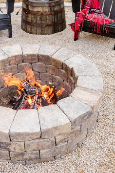 a fire pit sitting on top of a gravel field