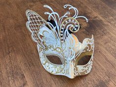 Created with the most elegant and gorgeous design with a beautiful butterfly on one side. The white and gold colors looks so elegant for anyone to wear on any events, Masquerade ball party, Carnivals, Mardi Gras, Halloween and more. This masquerade is lightweight and good quality material for long hours of comfortable wear, with black adjustable ribbon in the back. THE SIZE 6 inches tall and 6.5 inches wide. My shop www.etsy.com/shop/JVDesignAndEngraving JV Design & Engraving on Instagram. Elegant White Masquerade Mask For Carnival, Elegant White Masquerade Mask For Mardi Gras, White Masquerade Mask For Mardi Gras, White Masquerade Mask For Mardi Gras Gift, Elegant White Wedding Masquerade Mask, Elegant White Masquerade Mask For Weddings, White Formal Masquerade Mask For Carnival, White Venetian Masquerade Mask As Gift, White Venetian Masquerade Mask For Gift