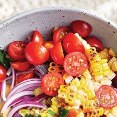 a bowl filled with pasta and vegetables on top of a table