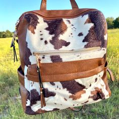 Convertible backpack Removable guitar strap Two zipper front pockets Back slip pocket Inside pockets Faux leather Dimensions: 14"L x 13"H x 7"D Convertible Backpack, Guitar Strap, Cow Print, Front Zipper, Inside Pocket, Convertible, Guitar, Zipper, Faux Leather