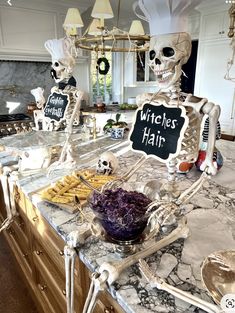 a skeleton sitting on top of a counter next to a bowl of food