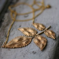 Update your fall wardrobe with hints of autumn leaves. Necklace designed and hand assembled by Mary Andrews, a jewelry designer and Artist dwelling in Brooklyn, NY. Piece comprised of a delicate gold toned leaf finding which hangs from a gold plated chain and finished with a gold plated wire clasp. * Necklace chain measures 18 inches in length and can be customized to your desired length, leave specific length in message to seller upon checkout. * Leaf component measures 3 1/2 inches long and 2 Golden Leaf, Golden Leaves, Popular Jewelry, Leaf Jewelry, Jewelry Model, Leaf Necklace, Leaf Pendant, Bridesmaids Gifts, Necklace Designs