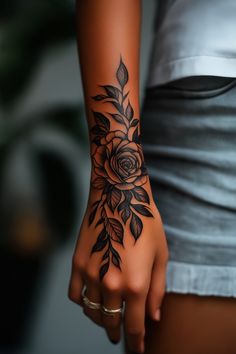 a woman's arm with a rose tattoo on it