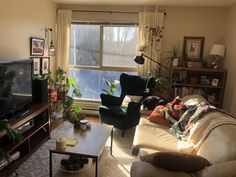 a living room filled with furniture and a flat screen tv