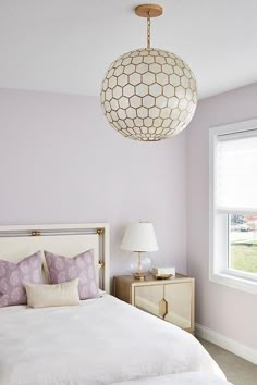 a bedroom with a white bed and purple walls