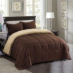 a bed with brown and tan comforters in a bedroom