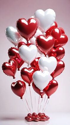 a bunch of red and white heart shaped balloons