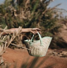 Handmade woven basket bags with braided leather short handles and an adjustable leather strap to wear over the shoulder or cross body. Handcrafted in Morocco, within a cooperative of Berber women, using basketry techniques passed down for generations. By supporting their crafts, we help these women achieve financial independence so that they become totally self-sufficient. Dimensions: XSmall Bag: 7.5" Height (Measured from the highest point of the bag) 5" Width (measured at bottom of the bag) Medium Bag: 9" Height (measured from highest point of the bag) 7" wide (measure at the bottom of the bag) Large Bag: 10" Height (measured from highest point of the bag) 10" Width (measure at the bottom of the bag) Materials: Main component palm and raffia,  Trim and handle are made from 100% leather Woven Leather Bucket Bag For Market, Artisan Bucket Bag With Braided Handles In Natural Color, Artisan Natural Bucket Bag With Braided Handles, Green Straw Bag With Braided Handles, Green Straw Bag With Braided Top Handles, Summer Straw Bag With Woven Leather And Round Handle, Eco-friendly Woven Leather Straw Basket Bag, Artisan Straw Bucket Bag With Leather Handles, Green Handwoven Straw Bag