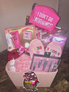 a pink gift box filled with lots of goodies for someone's special day