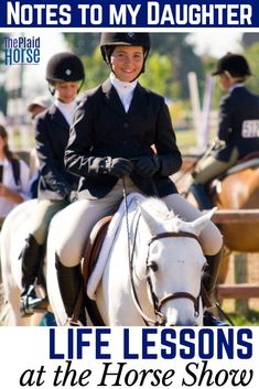 a woman riding on the back of a white horse in front of other people wearing equestrian gear