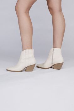 These booties are designed with a Western-inspired aesthetic, featuring classic details such as pointed toes, decorative stitching, and a stacked heel. They are typically ankle-high, making them suitable for various outfits, from jeans and dresses to skirts and shorts. The pointed toe adds a touch of sophistication, while the stacked heel offers comfort for extended wear. Style: Casual Silhouette: Booties Embellishment: NA Length: NA Closure: Zipper Heel Height: 3" Width: NA Made In: ChinaCare I Western Booties With Stacked Heel For Spring, Western Style Booties With Stacked Heel For Spring, Spring Ankle Boots With Stacked Heel, Ankle Boots With Stacked Heel For Spring, Spring Fitted Almond Toe Booties, Spring High Ankle Booties With Reinforced Heel, Trendy High Ankle Spring Booties, Spring Western Booties With Reinforced Heel, White Booties With Reinforced Heel For Spring