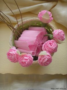 some pink flowers and soap in a basket