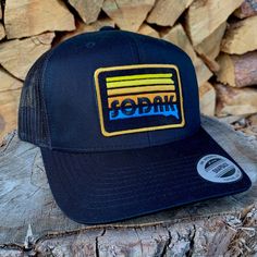 This sharp black SoDak Sunset trucker hat will be your new favorite! Great hat for any South Dakota adventure or just chilling and watching SoDak sunsets! The black snapback cap features my original SoDak Sunset patch, embroidered in bright colors on the front of the hat, with mesh in the back and an adjustable snapback closure. This hat will look great on guys and girls, one size fits most. Looking for a flat bill with this design? Go here: Visit my Oh Geez! Design shop home here: www.etsy.com/ Black Trucker Dad Hat With Curved Bill, Black Baseball Cap For Outdoor, One Size Fits Most, Black Retro Trucker Hat, Retro Black Trucker Hat For Streetwear, Retro Black Trucker Hat For Sports, Retro Black Trucker Hat With Curved Brim, Black Urban Trucker Hat With Curved Bill, Retro Black Baseball Cap With Flat Bill, Urban Black Trucker Hat With Curved Brim