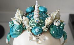 the headpiece is decorated with seashells and pearls