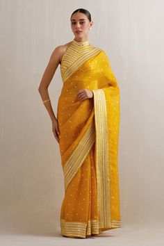 Mango yellow saree with aari, sequin, zari embroidery. Paired with halter neck embroidered blouse and petticoat. - Aza Fashions Transitional Gold Pre-draped Saree With Gota Work, Gold Chanderi Pre-draped Saree With Dori Work, Yellow Semi-stitched Chanderi Pre-draped Saree, Yellow Pre-draped Saree With Resham Embroidery, Transitional Yellow Chanderi Pre-draped Saree, Yellow Blouse With Resham Embroidery For Navratri, Navratri Yellow Blouse With Resham Embroidery, Yellow Resham Embroidery Blouse For Navratri, Yellow Tissue Silk Pre-draped Saree With Dori Work