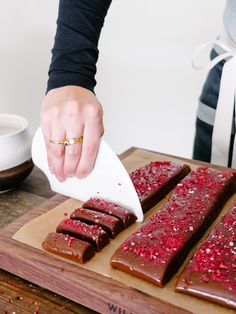 a person is cutting up some food on a board