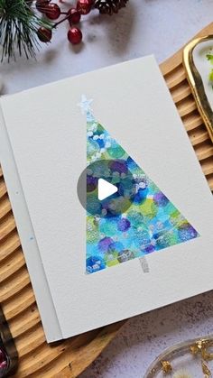 a card with a christmas tree on it next to some other decorations and ornaments,