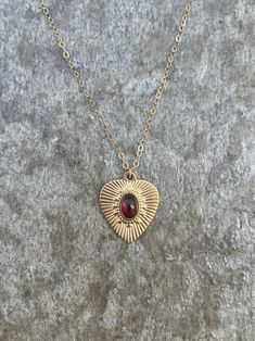 This necklace is handcrafted with an authentic 4x6mm garnet stone in a 19x16mm 14k gold-plated stainless steel setting. The stone is AAA quality. The chain is 14k gold-filled and will not tarnish easily.  This necklace is hypoallergenic. (Cadium free, lead free, and nickel safe) Garnet is an energizing stone that promotes passion and love.  The necklace comes in a ribbon-wrapped box, ready to be gifted. If you would like to leave a note for the recipient, you can do so during checkout. Garnet Heart Necklace, Garnet Heart, Garnet Stone, Heart Necklace, Crystal Necklace, Garnet, Gold Filled, Gold Plate, Jewelry Necklaces