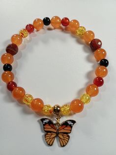 Orange and yellow butterfly  with mixed 8mm beads Amber Beaded Bracelets With Spacer Beads For Gifts, Amber Beaded Bracelets With Spacer Beads As A Gift, Amber Beaded Bracelet With Spacer Beads For Gift, Fall Color Bracelets, Cute Orange Handmade Jewelry, Adjustable Cute Orange Beaded Bracelet, Casual Yellow Beaded Bracelet With 8mm Beads, Casual Yellow Beaded Bracelets With 8mm Beads, Cute Orange Beaded Jewelry