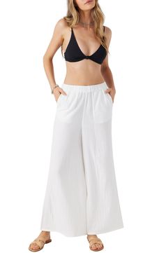 Crinkled double cotton gauze feels cool and airy against your skin in these pants with a comfortable elastic waist and flowy wide-leg silhoutte. Elastic waist Front slant pockets 100% cotton Machine wash, tumble dry Imported Bohemian Solid Wide Leg Pants For Beach, Neutral Color Bohemian Wide Leg Pants For Beach, Flowy Cotton Beach Bottoms, Flowy Cotton Bottoms For The Beach, Flowy Cotton Bottoms For Beach, Beach Wide Leg Cotton Pants, Wide Leg Beach Bottoms, Cotton Flowy Bottoms With Elastic Waistband, Flowy Cotton Bottoms With Elastic Waistband