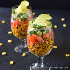 two wine glasses filled with food and garnish