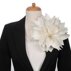 a white flower is attached to a black jacket