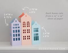 three paper houses sitting on top of a shelf with measurements for each house cut from a 12 x 12 sheet of paper