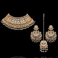 Evoke a sense of luxury and redefine glamor with our Sharmeen Set! Luxurious bridal set studded with jadau kundan stones, golden ball finish along with a stunning combination of green and pearl moti - making sure your big day will be as unforgettable as you are. The set includes a necklace, a matching maang teekah and a pair of beautiful earrings. Approximate earrings length is 3". Gold-plated on high-quality brass as base metal. Made by order. Kindly allow 5-7 weeks for the delivery of this ite Green Kundan Chandbalis For Reception, Elegant Kundan Bridal Sets With Zari Work, Elegant Green Lehenga With Stone Work, Green Lehenga With Stone Work For Reception, Green Kundan Traditional Wear With Stone Work, Kundan Lehenga With Hand Set Details For Reception, Green Bollywood Bridal Sets For Reception, Green Bridal Sets For Diwali Reception, Diwali Reception Green Bridal Sets