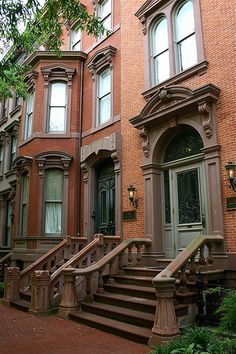 an old brick building with many windows and stairs