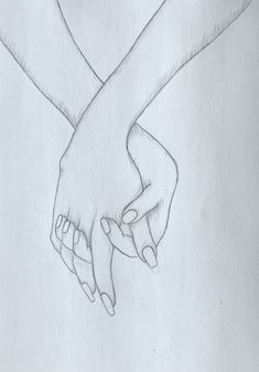 two hands holding each other in the shape of a heart on a white paper background