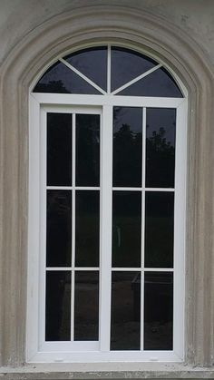 a cat sitting on the ledge of a window