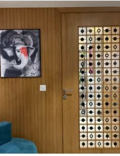 a room with wooden walls and pictures on the wall, along with a blue chair