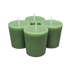 four green candles sitting next to each other