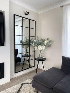 a living room filled with furniture and a large mirror