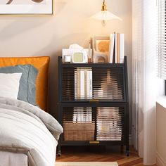 a bed room with a neatly made bed and a book shelf