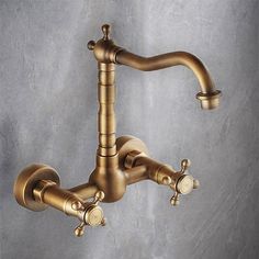 an antique brass faucet with two handles