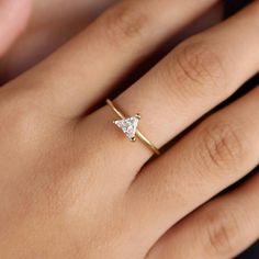 Elevate your everyday look with our 18k Gold Filled Trillion CZ Solitaire Ring. This delicate and gorgeous ring sparkles with a stunning trillion cut CZ stone, adding a touch of elegance to any outfit. The perfect blend of simplicity and luxury, it's a must-have for any stylish fashionista! DETAILS: * 18k gold-filled, Water resistant, CZ Stone MEASUREMENTS: * Size: 5 mm stone CARING TIPS: * Avoid contact with sweat, lotions & perfumes as these can tarnish the jewelry * Keep jewelry clean and dry  * We recommend using polishing cloths to restore the shine to your jewelry OTHER INFORMATION: * All items are packaged in elegant jewelry pouches * Have any questions? Feel free to contact us. We reply fast! MORE FROM US  https://leycorjewelry.etsy.com Instagram: @leycorjewelry 14k Gold Trillion Cut Diamond Promise Ring, Trillion Cut Diamond Promise Ring In 14k Gold, Minimalist Crystal Ring With Vs Clarity For Weddings, Trillion Cut Cubic Zirconia Diamond Promise Ring, Minimalist Trillion Cut Diamond Ring For Wedding, Minimalist Crystal Wedding Ring With Vs Clarity, Minimalist Heart Cut Diamond Ring For Anniversary, Trillion Cut Diamond Ring With Vs Clarity For Promise, Trillion Cut Vs Clarity Diamond Promise Ring