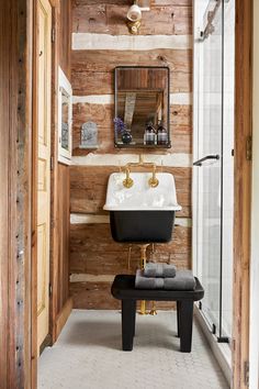 a bathroom with wood paneling and a white sink