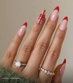 the cutest red french tip nails in an almond/oval shape with a ribbon on the ring finger Pretty Acrylic Nails, Holiday Nails, Trendy Nails