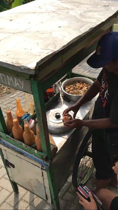 a man sitting at a table with food in front of him