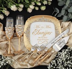 a table setting with champagne glasses and silverware